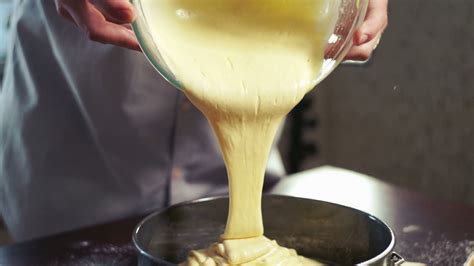 Cake batter pouring into baking dish. Home baking. Closeup. Baking cake ...