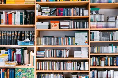 Bookshelf with books and cds, background, bookcase, bookstore wallpaper | Wallpaper bookshelf ...