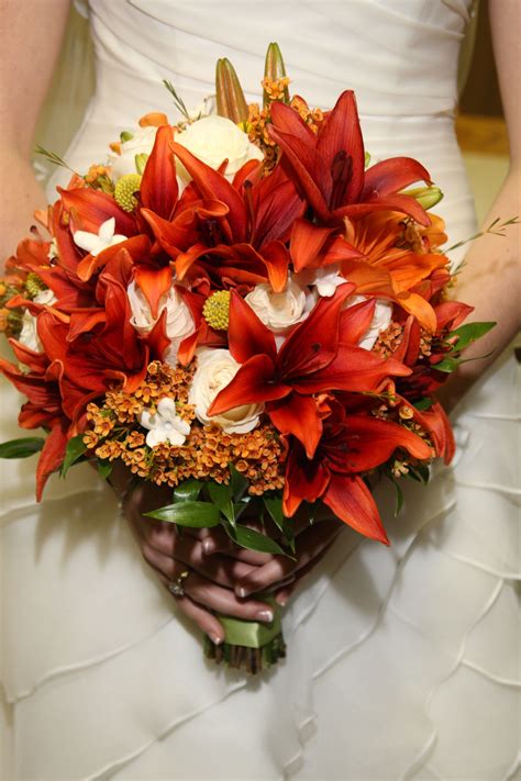 Bride's fall bouquet, burnt orange lilies and ivory roses. | Orange wedding flowers, Burnt ...