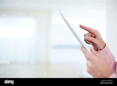 In touch with the business world. Cropped shot of a businesswomans