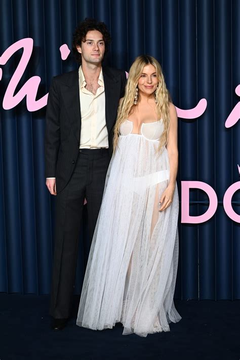 Sienna Miller shows off baby bump in see-through look