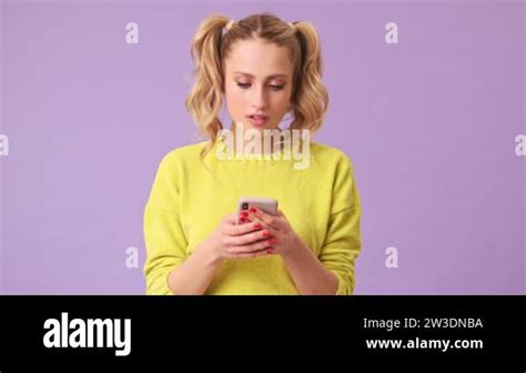 An Incredible Blonde Girl Writes A Message To Her Friend On The Phone Winks And Sends A Kiss To