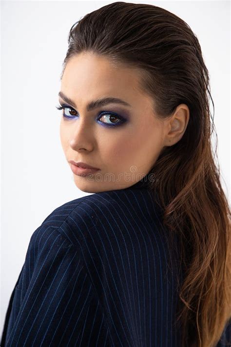 Close Up Portrait Of Face Of Beautiful Brunette With Dark Long Hair Combed Back Bright Makeup