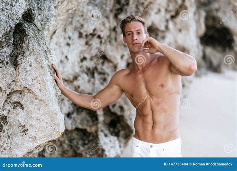 Muscular Athletic Man In White Pants With A Naked Torso On The Beach Stock Photo Image Of