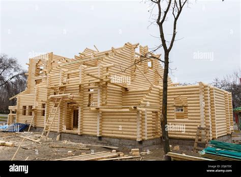 Construction Of A Christian Church Made Of Wooden Treated Logs By Hand