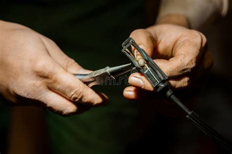 A Craftsman Repairing Electrical Wiring with Precision Tools Stock ...
