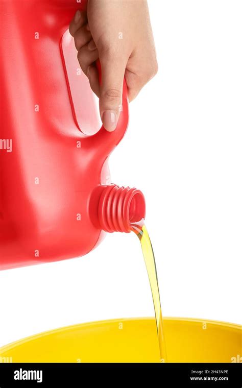 Woman Pouring Motor Oil From Canister Against White Background Stock