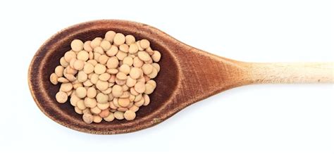 Premium Photo Raw Lentils In A Wooden Spoon