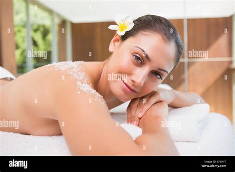 Beautiful Smiling Brunette Lying On Massage Table With Salt Scrub On