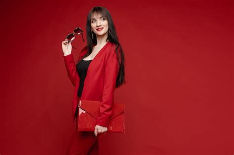 Premium Photo Side View Of Glamorous Brunette Posing In Red Suit