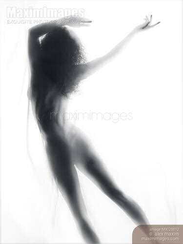 Photo Of Beautiful Surreal Silhouette Of A Nude Woman Figure In Glowing Foggy Light Stock