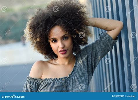 Young Black Woman With Afro Hairstyle Smiling In Urban Background Stock