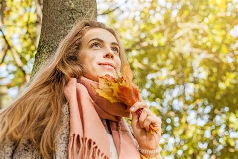 Romantic Girl Dreams In Autumn Fall Park Cute Woman Holding Yellow