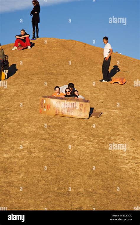 People Sliding Down A Hill On Cardboard Boxes Stock Photo Alamy