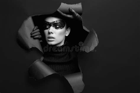 Elegant Brunette Woman In Turtleneck Sweater And Sequins Mask Stock