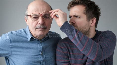 Surprised Stupefied Men Mature Father And Son In Big Glasses With WOW Expression Stock Photo