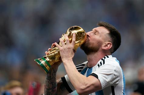 Lionel Messi Kisses The Trophy After Argentina Won The 2022 Fifa World Cup In Qatar