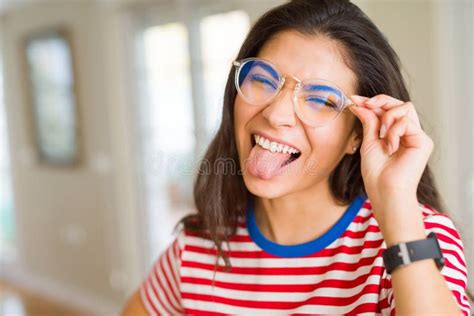 Young Beautiful Woman With Tongue Out Posing Doing Funny Faces Stock