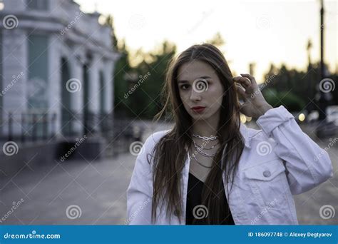 Attractive Brunette Portrait The Girl Touches Her Hair With Her Hand Stock Photo Image Of