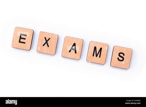 The Word Exams Spelt With Wooden Letter Tiles Stock Photo Alamy