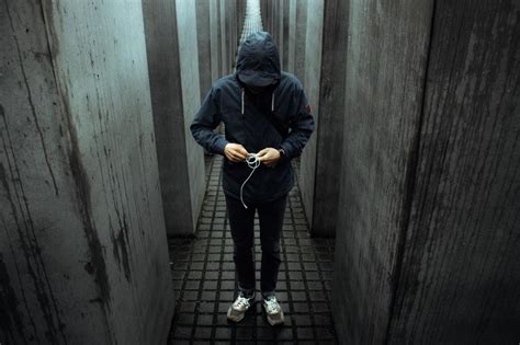 Free Stock Photo Of Man In Hooded Jacket Walking Down Narrow Hallway