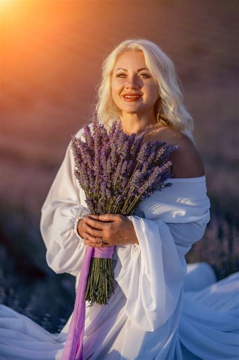 Blonde Woman Poses In Lavender Field At Sunset Happy Woman In White Dress Holds Lavender