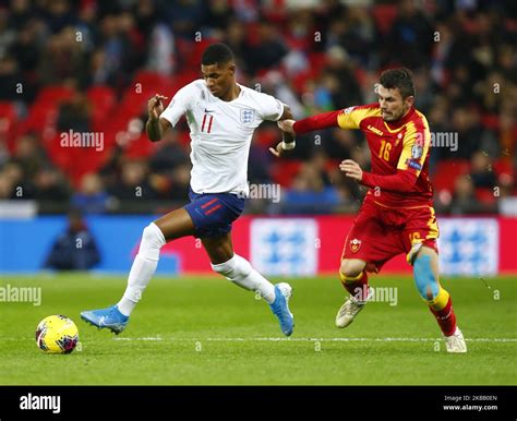 Marcus Rashford of England under pressure from Vladimir Jovovic of ...