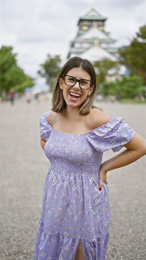 Cheerful Latin Beauty In Glasses A Brunette Woman Poses With A Confident And Carefree Smile At