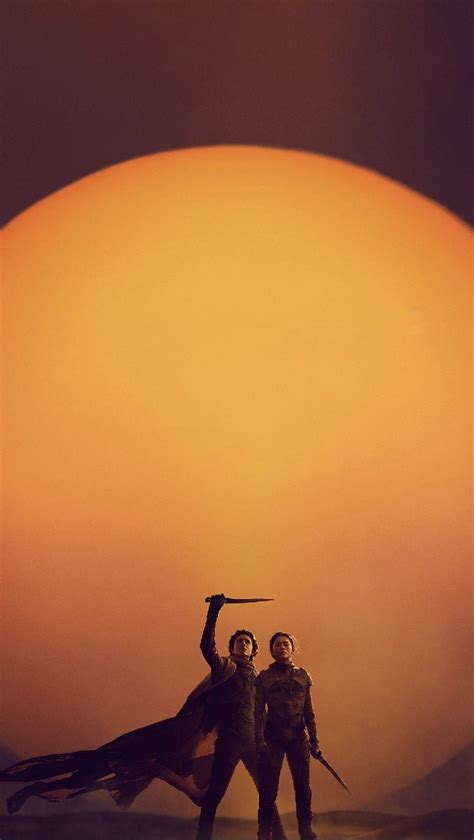 Two People Holding Swords In Front Of The Sun