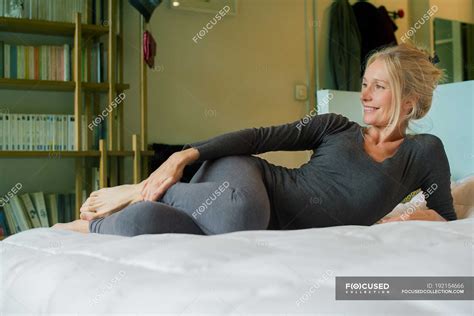 Mature Woman Relaxing On Bed Home Caucasian Stock Photo