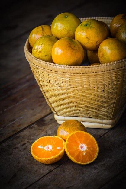 Premium Photo High Angle View Of Orange Fruits In Basket On Table