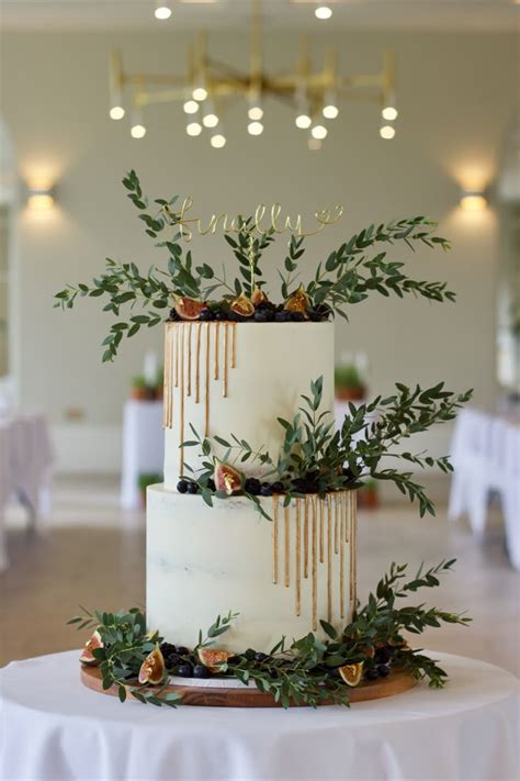 Semi Naked Two Tier Cake With Bronze Drip Blueberries Blackberries Figs Gold Leaf And Eucal