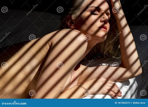 Gorgeous Blonde Model Poses Nude In A Home Environment Stock Photo