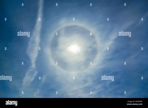 A 22 Degree Halo Around The Full Moon In A Sky Of High Cirrus Clouds