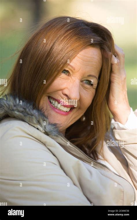Portrait Attractive Beautiful Mature Woman Sitting Happy Relaxed With Joyful Smile Outdoors
