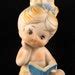 Vintage Bisque Nude Baby Girl With Book And Blue Flower Ribbon In Hair Made In Japan Bare