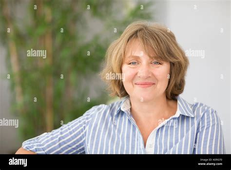 Portrait Of Smiling Blonde Middle Age Woman In The Room Stock Photo Alamy