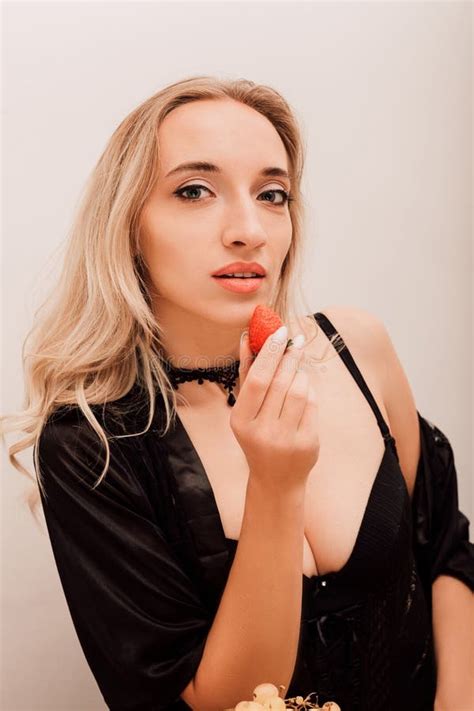 Woman Eating Strawberries Blonde Woman In Kitchen Eating Berries Stock Image Image Of Fruit