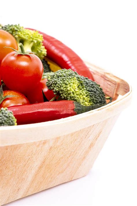 A Light Wooden Basket Filled with Ripe Cherry Tomatoes, Broccoli Chunks