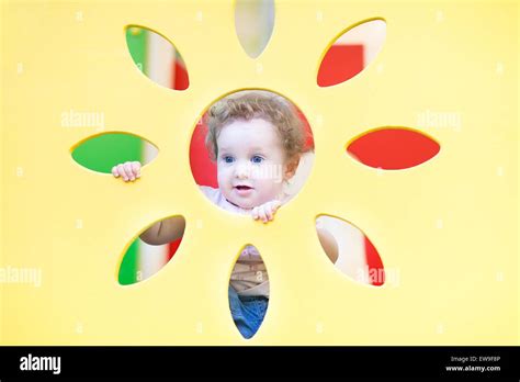 Funny Curly Baby Girl Playing Hide And Seek Stock Photo Alamy