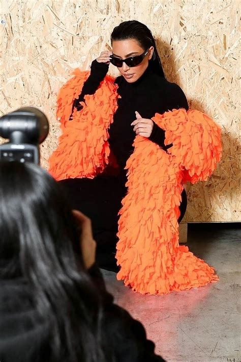 Kim Kardashian Accessorizes With A Bright Orange Feather Boa At