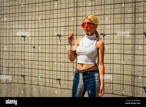 A Beautiful Latina Woman In A T Shirt Standing In Front Of A Wall Stock Photo Alamy