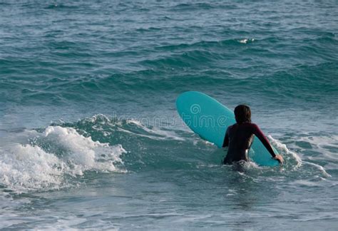 girl  woman practicing surf sport  winter season   poetto