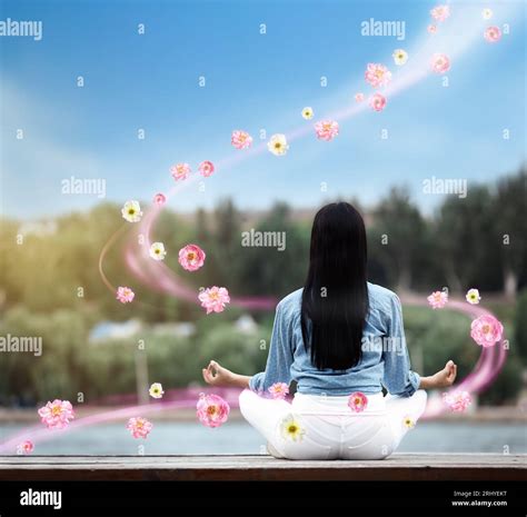 Woman Meditating Near River Back View Flowers Flying Around Her