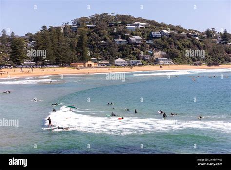 People surfing in the ocean off Palm Beach on Sydney northern beaches ...