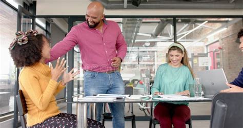 Happy Diverse Business People Clapping Hands At Meeting In Office In