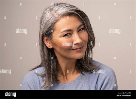 Charming Asian Mature Woman Smiles At Camera Stock Photo Alamy