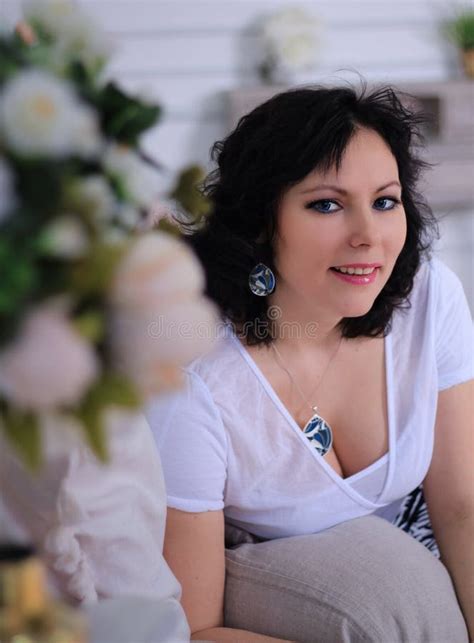 Long Legged Brunette Model In White Stockings And Miniskirt Shows Her Incredible Legs On Sofa