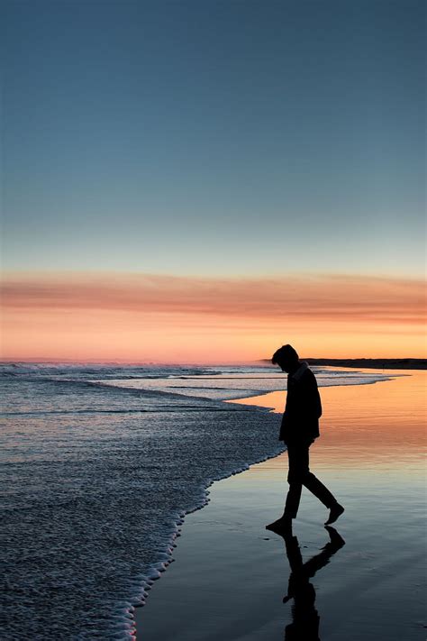 Silhouette Of Person Walking On Beach During Sunset Human Alone Man