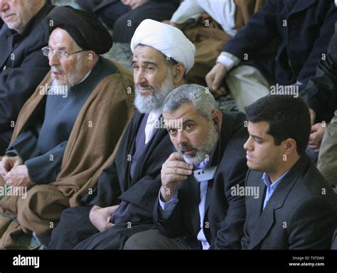 Palestinian Prime Minister Ismail Haniyeh (C) listens to the sermons of Friday prayers at the ...